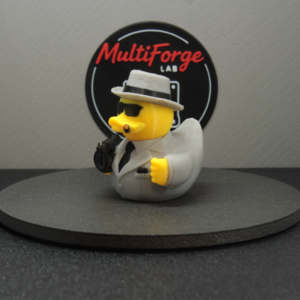 Speakeasy Kingpin collectible duck with yellow skin, gray suit and black Thompson-style prop gun