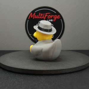 Rear three quarter view of the Speakeasy Kingpin figurine showing its gray suit and grey fedora